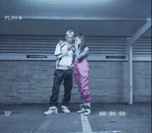 a woman smoking a cigarette next to a man with a play button on the bottom
