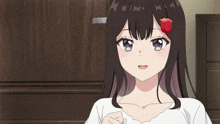 a girl with a red rose in her hair looks at the camera