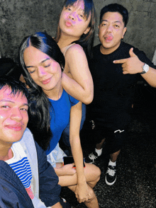 a group of people posing for a picture with one wearing a watch
