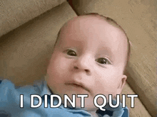 a baby is laying on a couch with the words `` i didnt quit '' written on its face .