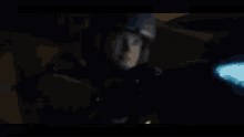 a man is riding a motorcycle in a dark room