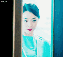 a woman in a blue dress is looking out a window with the hashtag @wd_329