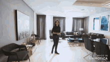 a woman is standing in a living room with the words made in animotica on the bottom