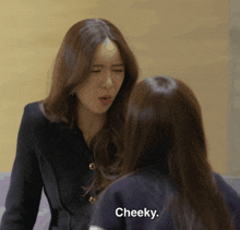 two women are standing next to each other and one of them says " cheeky "