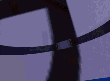 a close up of a yellow and purple object with a blue background