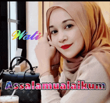 a woman wearing a hijab is sitting at a table with a louis vuitton purse in the background