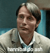 a man in a suit and tie is making a funny face with the words `` hannibal do ash '' .