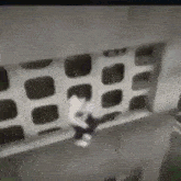 a person is jumping off a balcony into the air .