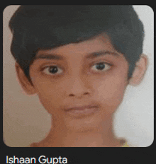 a close up of a young boy 's face with the name ishaan gupta below it