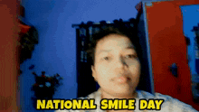 a woman is smiling in front of a sign that says " national smile day "