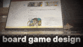 a laptop is open to a page that says board game design on it