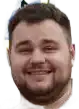 a close up of a man 's face with a beard smiling on a white background .
