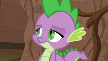 a cartoon of a purple and green dragon looking sad