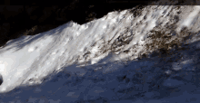a large pile of snow is sitting on a hill