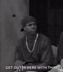 a black and white photo of a man sitting down with the words `` get outta here with that '' written on the bottom .