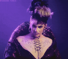a woman with a tattoo on her chest and a purple background that says @vonxodd tumblr