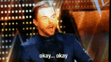 a man in a suit says okay okay