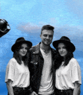 a man and two women are posing for a photo