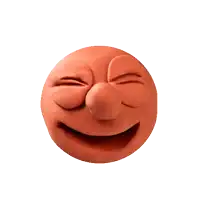 a clay smiley face with tears coming out of its eyes