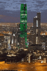 a city skyline with a green building in the middle