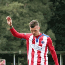 a man in a red and white striped jersey with the word stonegate on the front