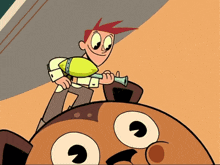 a cartoon character with red hair is holding a green object in his hand