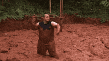 a man is kneeling in a muddy field
