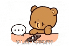 a teddy bear is sitting at a table using a cell phone and a speech bubble .