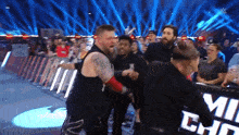 a group of wrestlers are standing in front of a sign that says miz