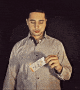 a man in a shirt is holding a stack of money in his hand