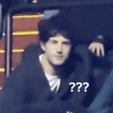 a person sitting in a chair with a question mark on the back of their head