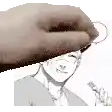 a hand is holding a key in front of a smiling man .