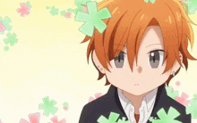 a close up of a person with orange hair and green flowers in the background .