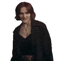a woman with red hair is wearing a black coat and black top
