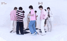 a group of young men are standing in a circle with one wearing a number 19 shirt