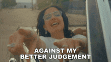 a woman in a car with the words " against my better judgement " below her
