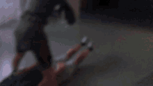 a blurry picture of a person laying on the ground with their legs crossed .