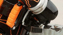 a close up of a toy with a black and orange item on it