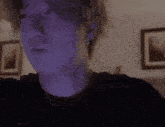 a close up of a person 's face in a room with a shadow on his face .