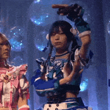 a girl in a blue and white dress is dancing on stage