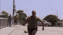 a man without a shirt is running down the street