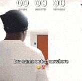 a man standing in front of a wall that says 00 hours minutes seconds and bro came out of nowhere