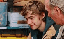 a man and a boy are sitting next to each other and the boy is smiling