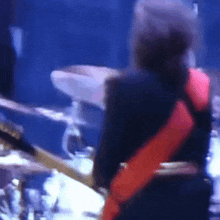 a blurry picture of a person playing drums