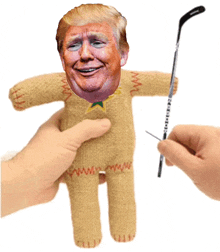 a doll with donald trump 's face on it is being sewn together
