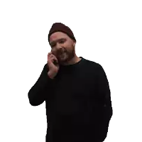 a man wearing a beanie is talking on a cellphone