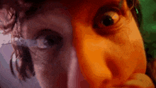a close up of a person 's face with a purple background