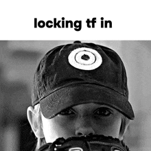 a black and white photo of a woman wearing a hat with a target logo on it