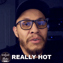 a man wearing glasses says really hot