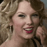 a close up of a woman 's face with blonde hair and red lips
